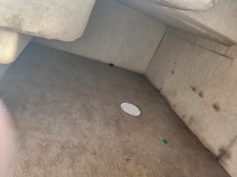 Slide: The Image of Interior cabin of 2001 Sea Ray 240 Sundancer boat, showing carpeted floor and walls. - 11