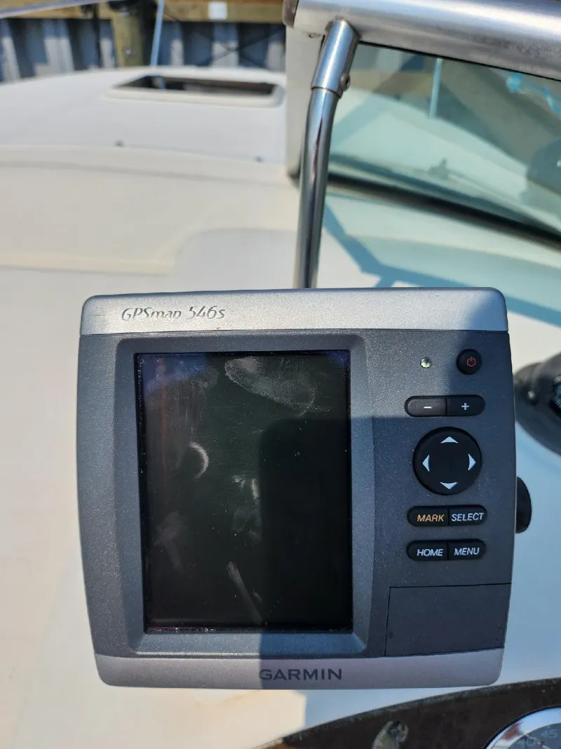 Slide: The Image of Garmin GPS device on 2001 Sea Ray 240 Sundancer boat dashboard. - 14