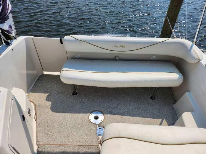 Slide: The Image of 2001 Sea Ray 240 Sundancer boat interior with seating, overlooking water. - 15