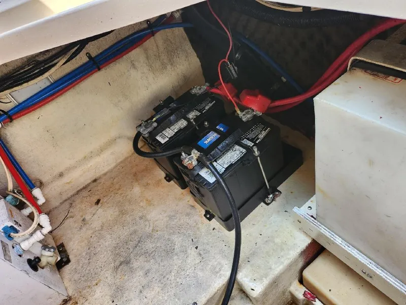 Slide: The Image of Battery compartment of a 2001 Sea Ray 240 Sundancer boat, showing wiring and connections. - 18