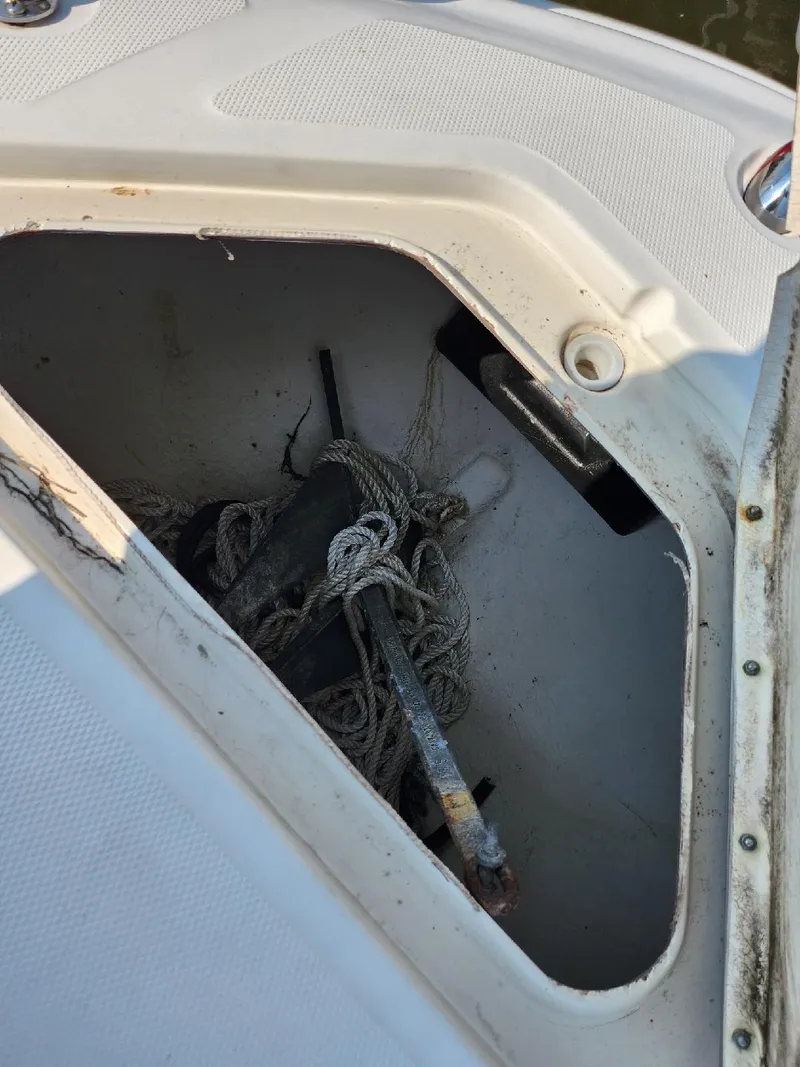Slide: The Image of Storage compartment on a 2001 Sea Ray 240 Sundancer boat with ropes inside. - 19