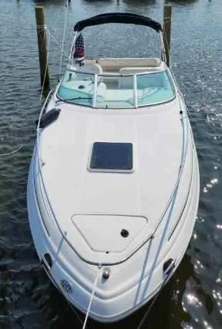 Slide: The Image of 2001 Sea Ray 240 Sundancer boat docked on calm water. - 20