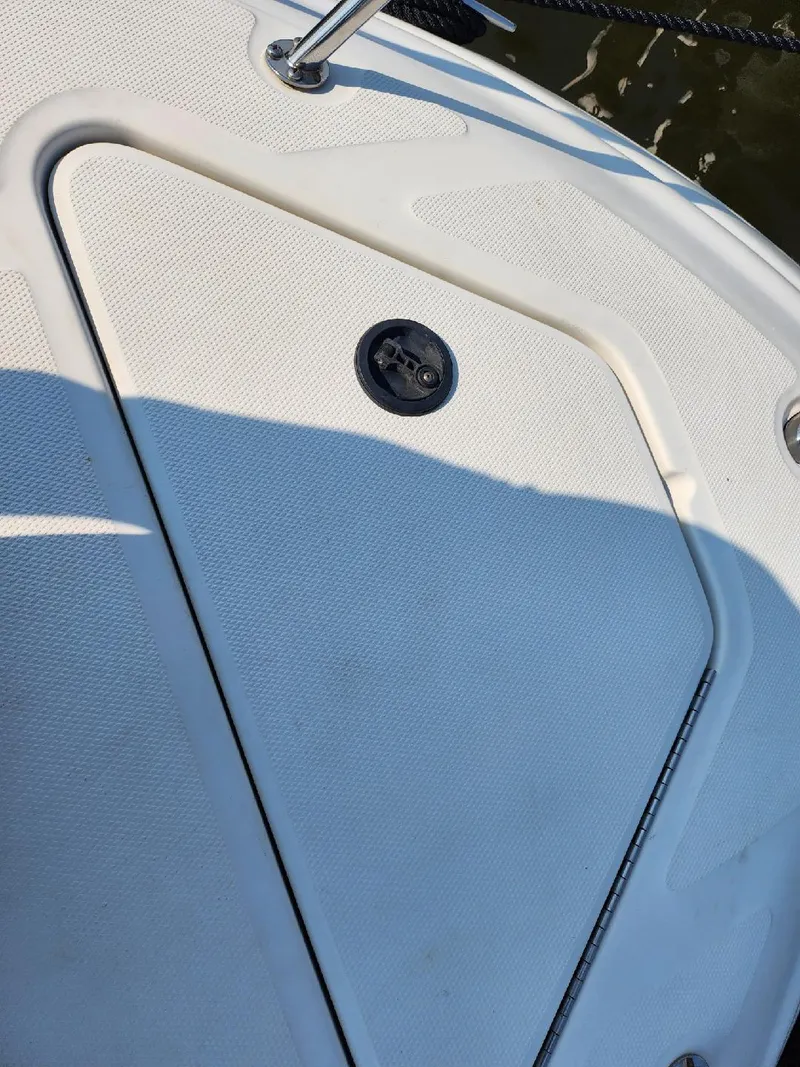 Slide: The Image of 2001 Sea Ray 240 Sundancer boat deck with hatch and latch. - 21