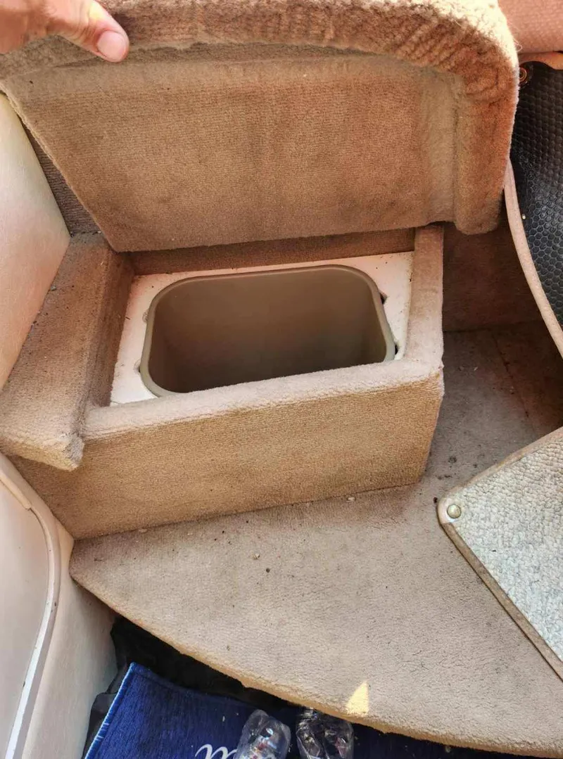 Slide: The Image of Storage compartment on 2001 Sea Ray 240 Sundancer boat, open lid, beige interior. - 4