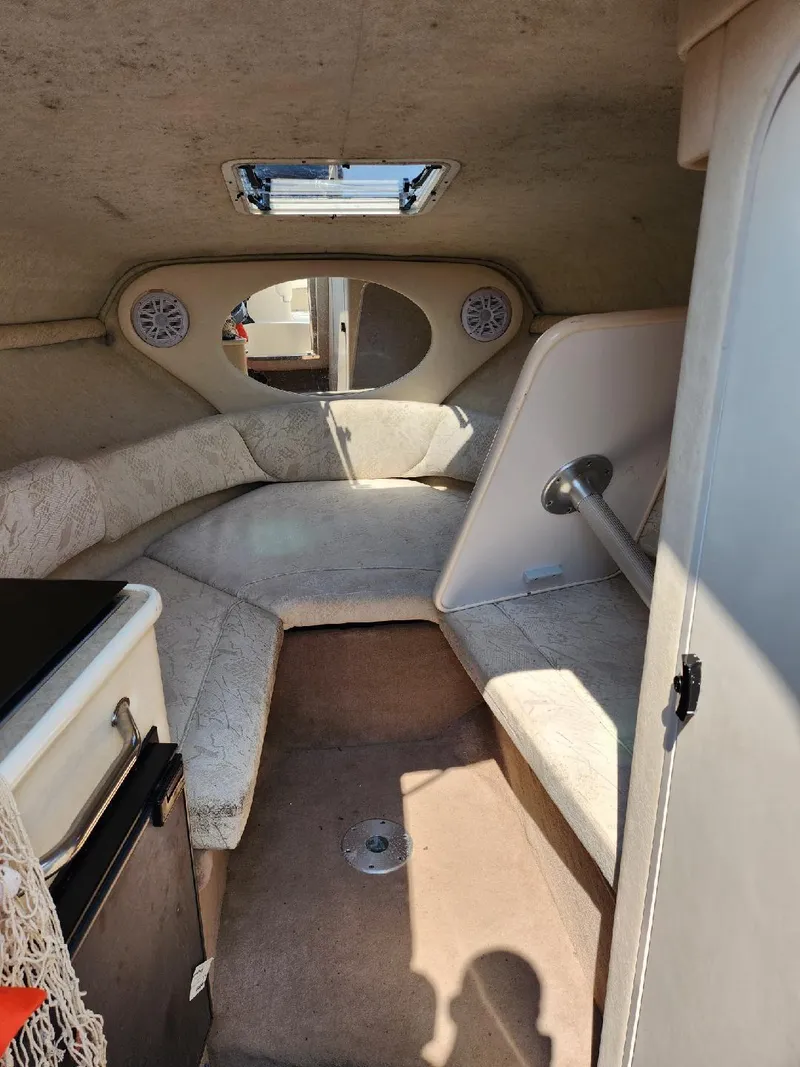 Slide: The Image of 2001 Sea Ray 240 Sundancer cabin interior with seating and storage. - 5