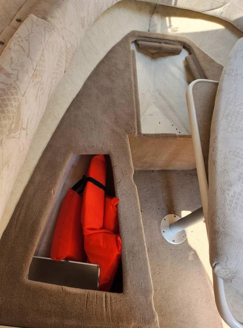 Slide: The Image of 2001 Sea Ray 240 Sundancer interior with storage compartments and life jackets. - 6