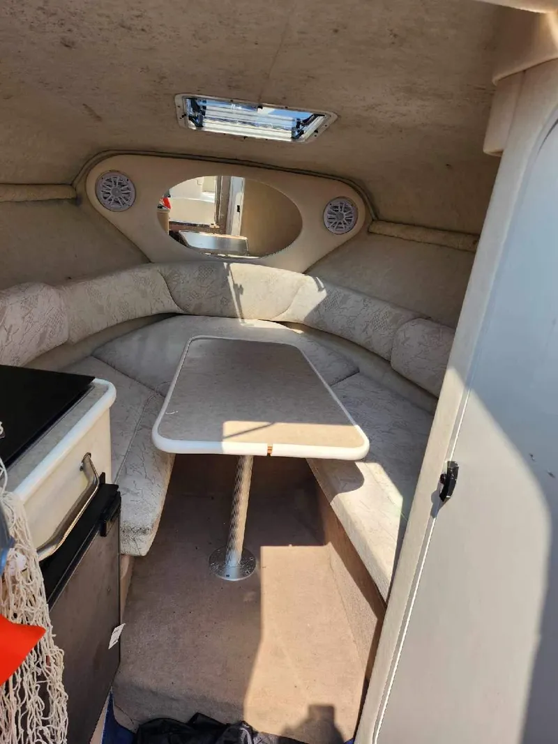 Slide: The Image of 2001 Sea Ray 240 Sundancer cabin interior with seating and table. - 7