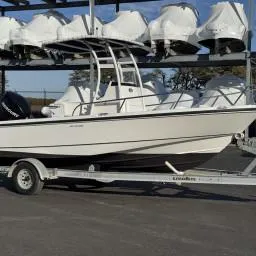 Slide: The Image of 2007 Boston Whaler 190 Outrage boat on trailer, parked outdoors. - 13