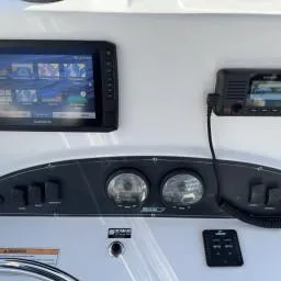 Slide: The Image of Dashboard of a 2007 Boston Whaler 190 Outrage with navigation and communication equipment. - 14