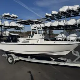 Slide: The Image of 2007 Boston Whaler 190 Outrage boat on trailer, stored outdoors under clear sky. - 3