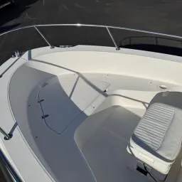 Slide: The Image of 2007 Boston Whaler 190 Outrage boat interior, featuring seating and railing. - 8