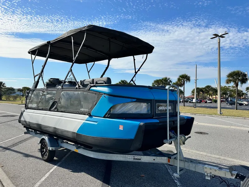 Slide: The Image of 2023 Sea-Doo Switch Cruise 21 on trailer, parked outdoors under a clear sky. - 5