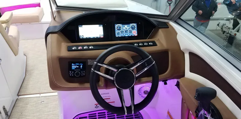 Slide: The Image of 2019 Cobalt 25SC boat dashboard with steering wheel and illuminated controls. - 10