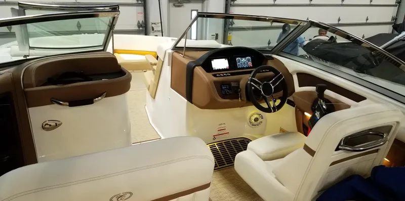 Slide: The Image of 2019 Cobalt 25SC boat interior with modern dashboard and luxurious seating. - 9
