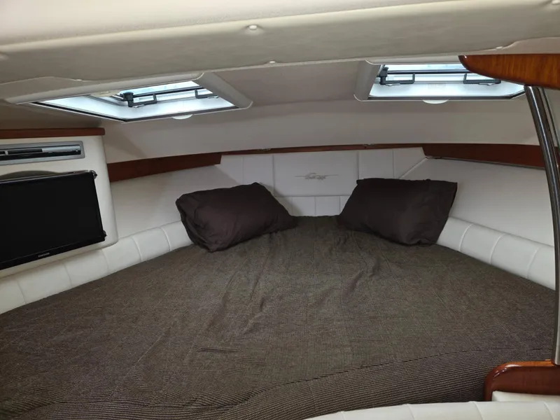 Slide: The Image of 2007 Grady-White Express 360 cabin interior with bed, pillows, and windows. - 10