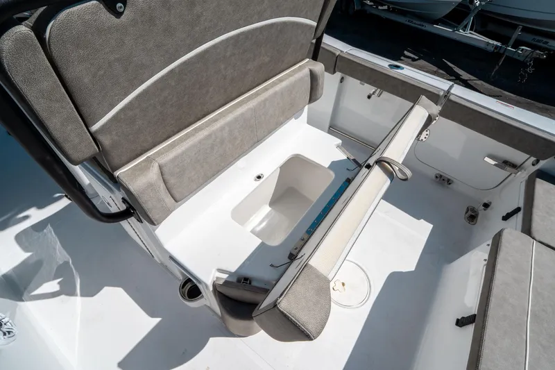 Slide: The Image of 2025 Sea Hunt Ultra 265 SE boat interior with foldable seating and storage compartment. - 17