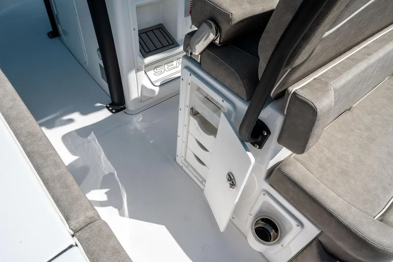 Slide: The Image of 2025 Sea Hunt Ultra 265 SE boat interior with seating and storage compartment. - 19
