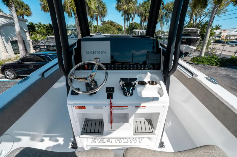 Slide: The Image of 2025 Sea Hunt Ultra 265 SE boat dashboard with Garmin navigation system and steering wheel. - 23