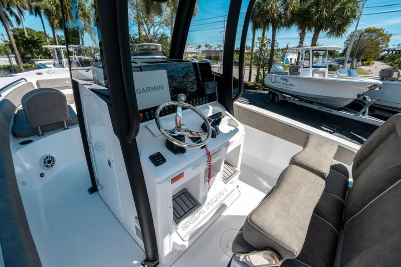 Slide: The Image of 2025 Sea Hunt Ultra 265 SE boat interior with Garmin navigation system and seating. - 24