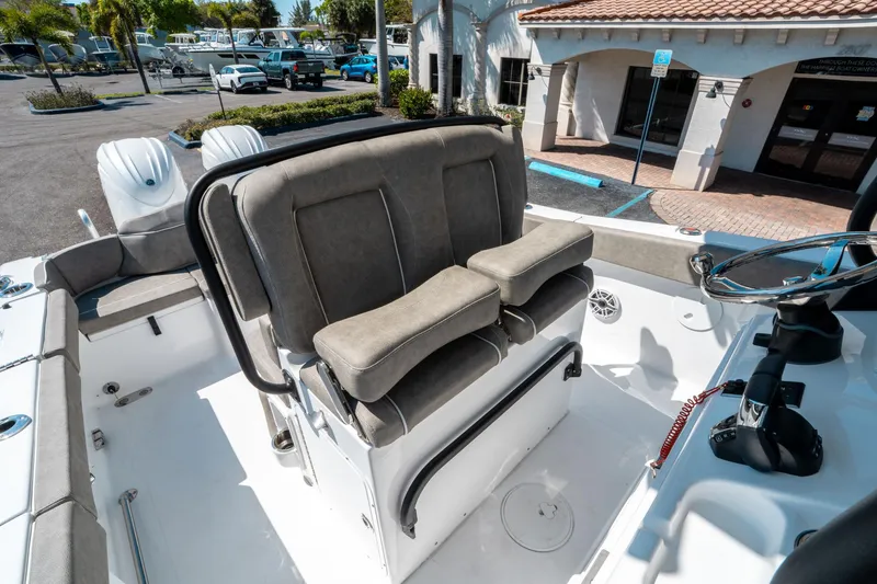 Slide: The Image of 2025 Sea Hunt Ultra 265 SE boat interior with cushioned seating and steering wheel. - 27