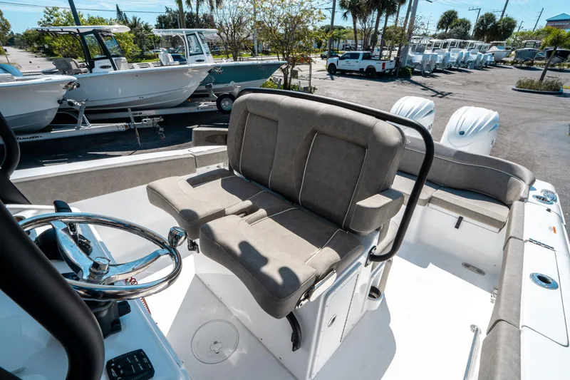 Slide: The Image of 2025 Sea Hunt Ultra 265 SE boat interior with seating and steering wheel. - 28