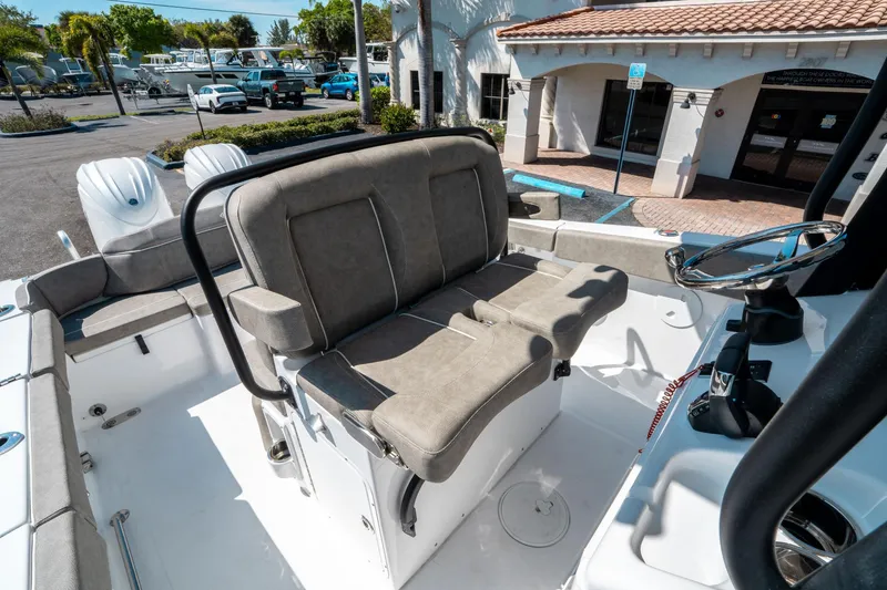 Slide: The Image of 2025 Sea Hunt Ultra 265 SE boat interior with dual seating and steering wheel. - 29
