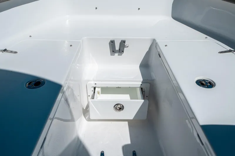 Slide: The Image of 2025 Sea Hunt Ultra 265 SE boat interior with open storage compartment. - 38