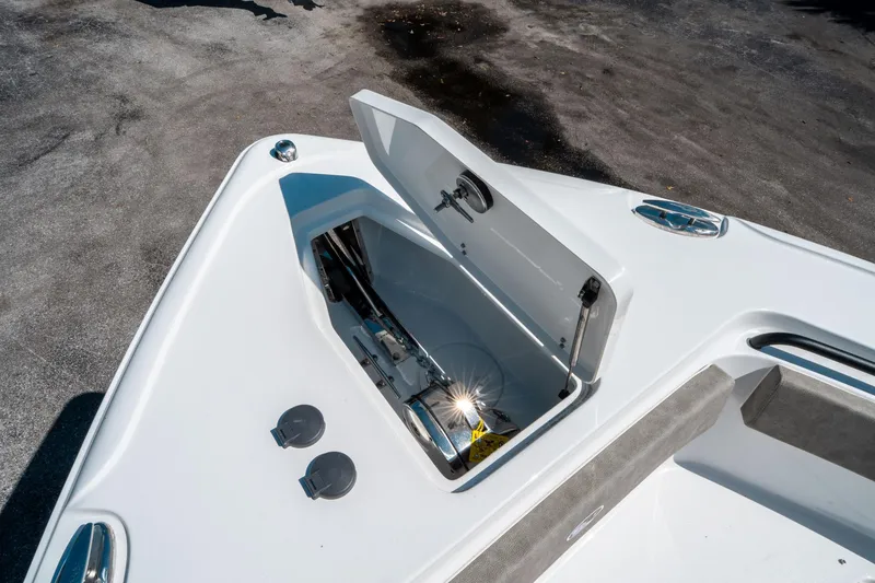 Slide: The Image of 2025 Sea Hunt Ultra 265 SE boat anchor compartment, open lid, showcasing storage space. - 40