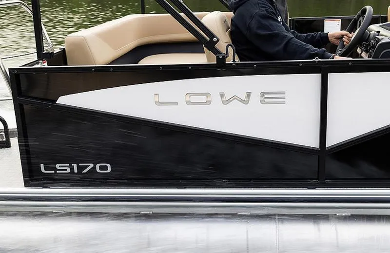 Slide: The Image of 2025 Lowe LS170 boat side view, sleek black design, person steering. - 5
