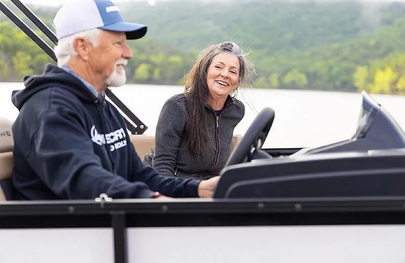 Slide: The Image of Couple enjoying a ride on a 2025 Lowe LS170 boat, smiling on a lake. - 6