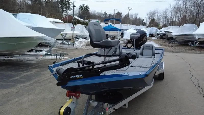 Slide: The Image of Avid 20 Vertex 2025 boat on trailer in marina, surrounded by covered boats. - 2