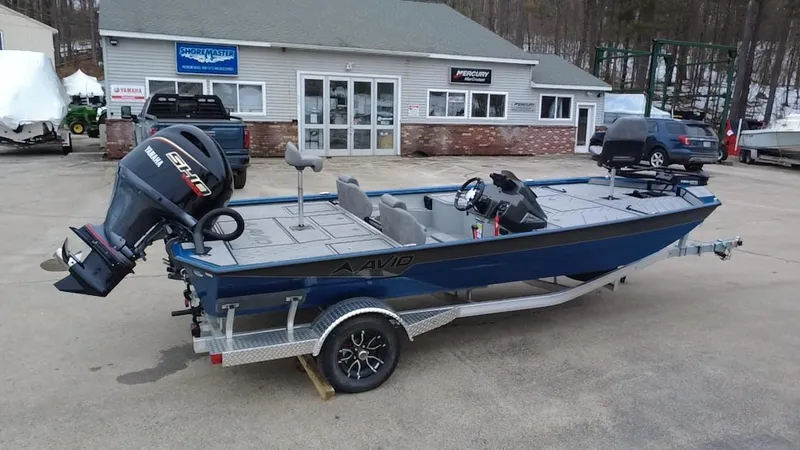 Slide: The Image of 2025 Avid 20 Vertex boat with motor on trailer, parked outside dealership. - 5