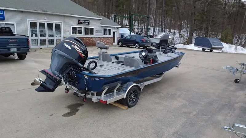Slide: The Image of 2025 Avid 20 Vertex boat on trailer, parked outside dealership, featuring Yamaha outboard motor. - 6