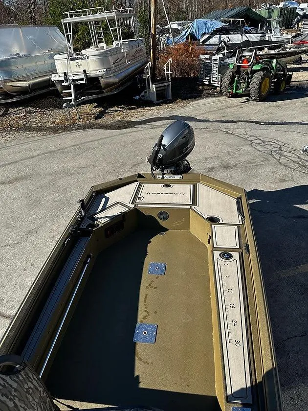 Slide: The Image of 2025 Avid 16 Commander boat in a marina, surrounded by other boats and equipment. - 3