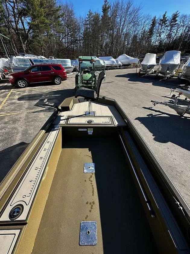 Slide: The Image of 2025 Avid 16 Commander boat in a parking lot, surrounded by vehicles and trees. - 4