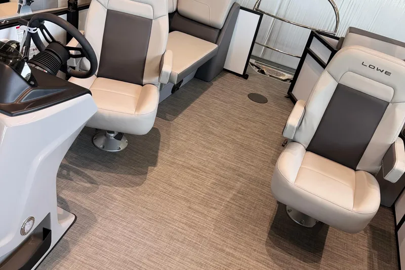 Slide: The Image of 2025 Lowe LS 210 WT boat interior with modern seating and steering console. - 3