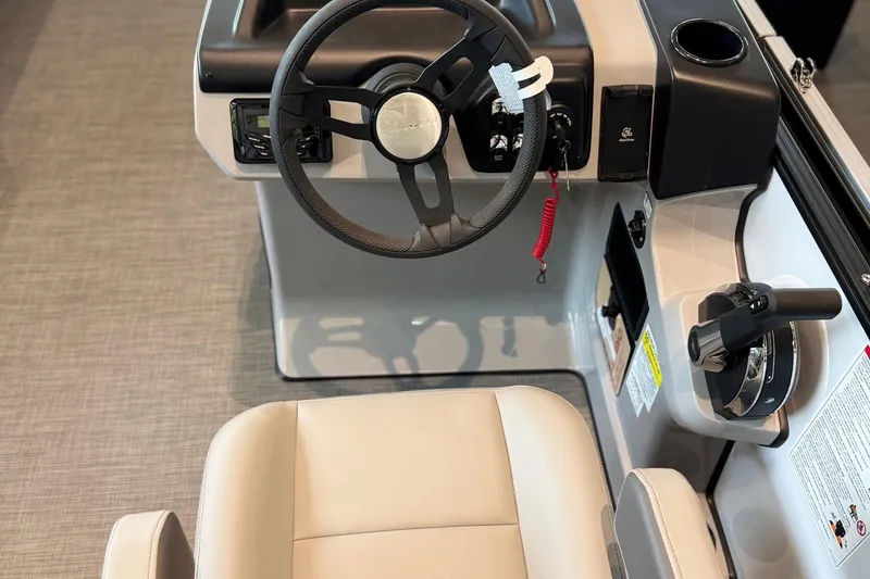 Slide: The Image of Interior view of 2025 Lowe LS 210 WT boat cockpit with steering wheel and controls. - 4