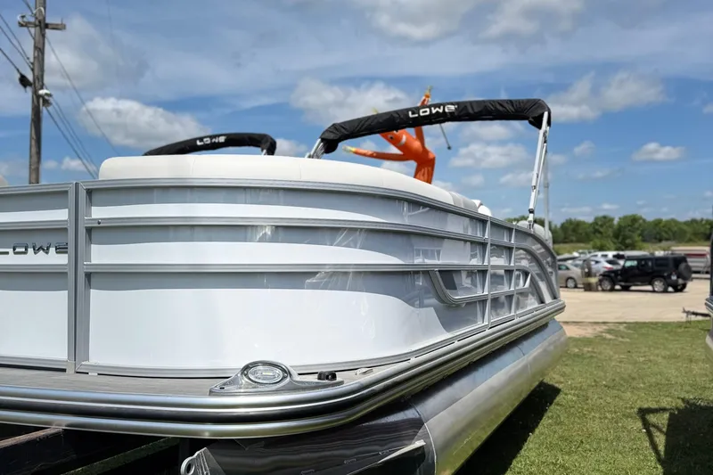 Slide: The Image of 2025 Lowe LS 210 WT pontoon boat interior with seating and steering console. - 9