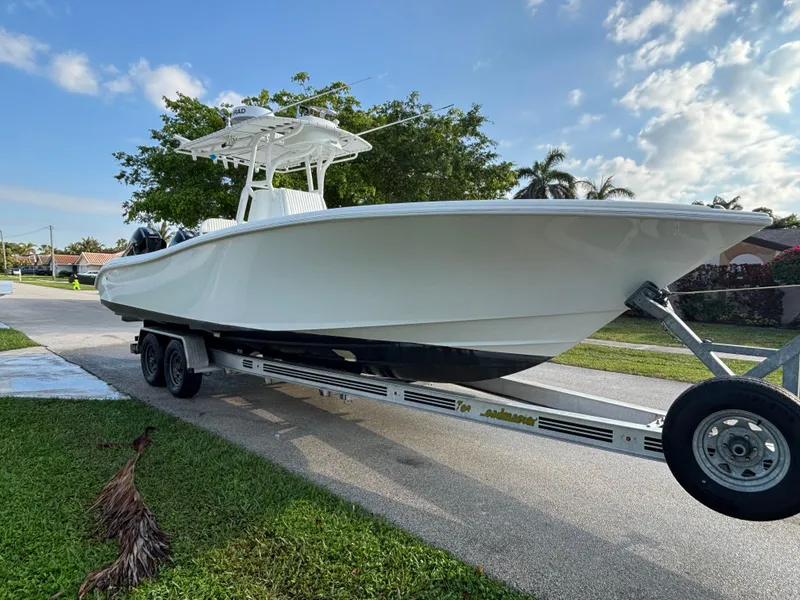 Slide: The Image of 2012 Yellowfin 29 boat on trailer, parked on a suburban street. - 1