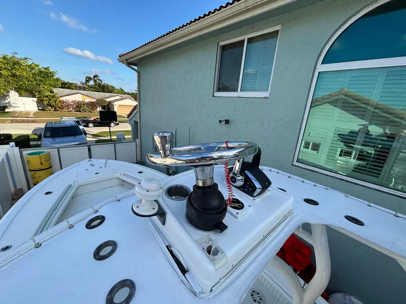 Slide: The Image of 2012 Yellowfin 29 boat deck with winch, parked near a house. - 10
