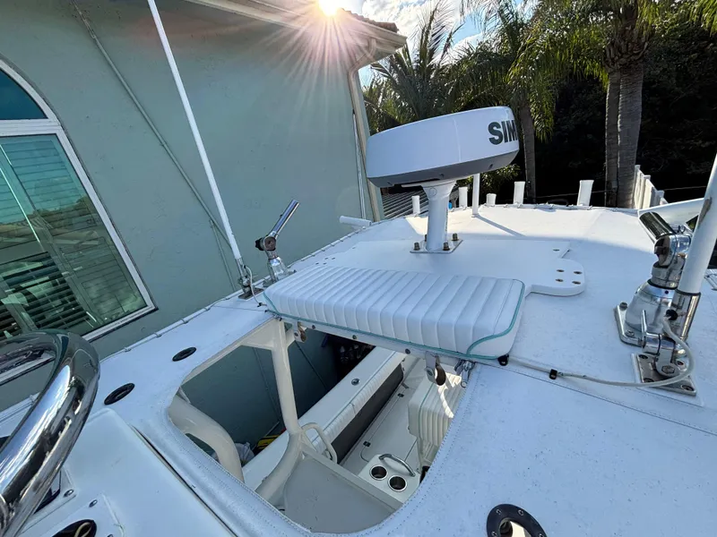 Slide: The Image of 2012 Yellowfin 29 boat deck with radar and seating, under sunlight. - 11