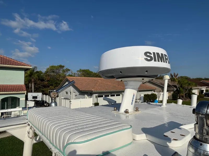 Slide: The Image of 2012 Yellowfin 29 boat with Simrad radar, rooftop view, clear sky background. - 13