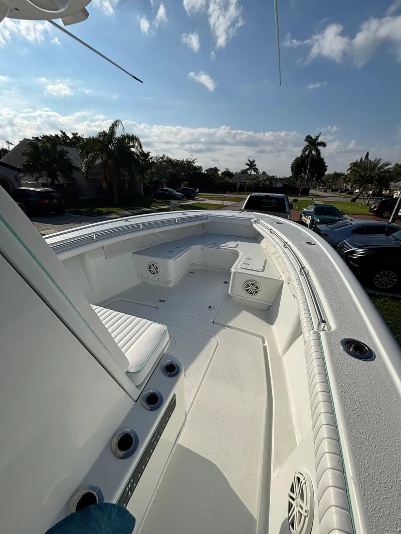 Slide: The Image of 2012 Yellowfin 29 boat deck with seating, under a partly cloudy sky. - 16