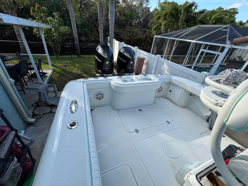 Slide: The Image of 2012 Yellowfin 29 boat with dual engines, spacious deck, and outdoor setting. - 19