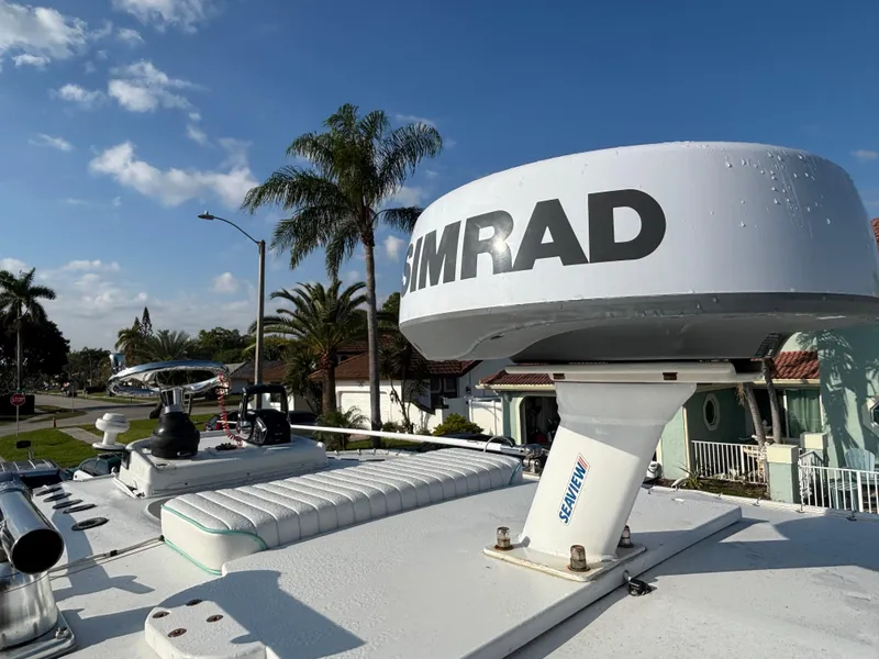 Slide: The Image of 2012 Yellowfin 29 boat with Simrad radar, palm trees in the background. - 20