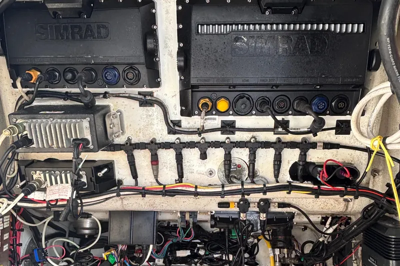 Slide: The Image of 2012 Yellowfin 29 boat electronics panel with Simrad systems and wiring. - 23