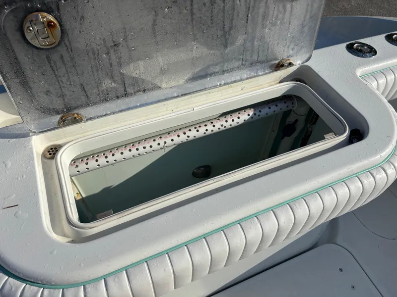 Slide: The Image of Open storage compartment on a 2012 Yellowfin 29 boat, featuring a clean, white interior. - 5