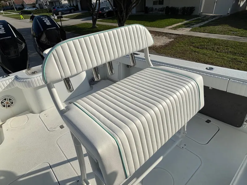 Slide: The Image of 2012 Yellowfin 29 boat with white cushioned seating and dual outboard motors. - 6