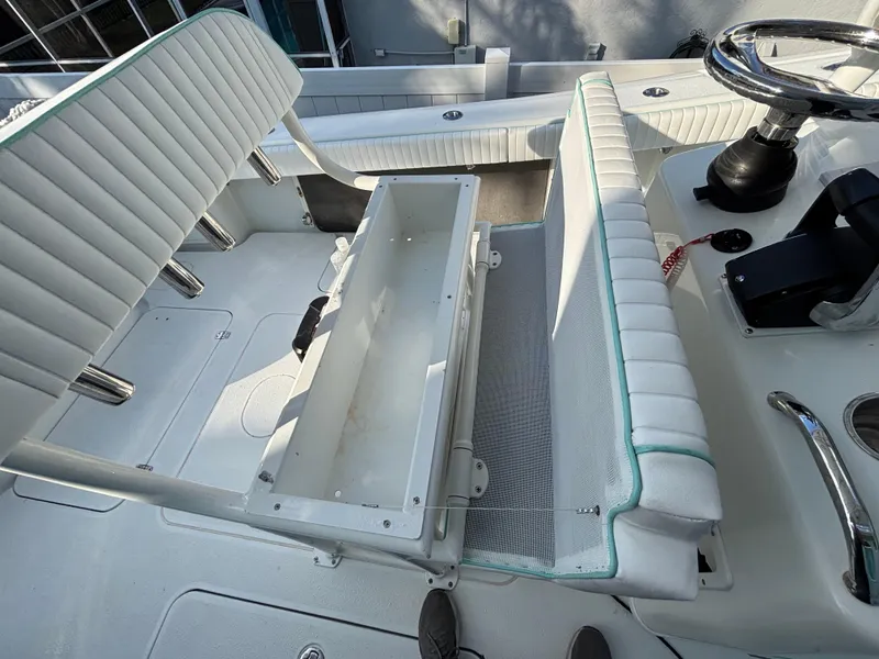 Slide: The Image of 2012 Yellowfin 29 boat interior with white seating and storage compartment. - 7