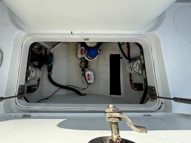 Slide: The Image of 2012 Yellowfin 29 boat compartment with visible mechanical components and wiring. - 9